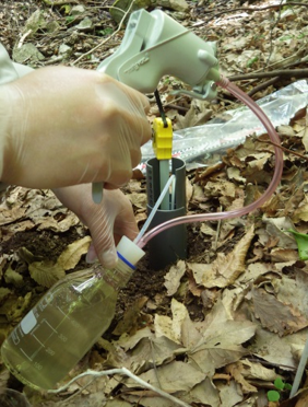 Pumping underground water from observation hole using a hand pump